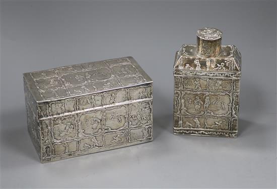 A 19th century Dutch oblong white metal tea canister and cover, embossed with figures and scrolls and a Dutch 833 embossed box.